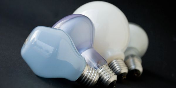 Three light bulbs on a dark surface